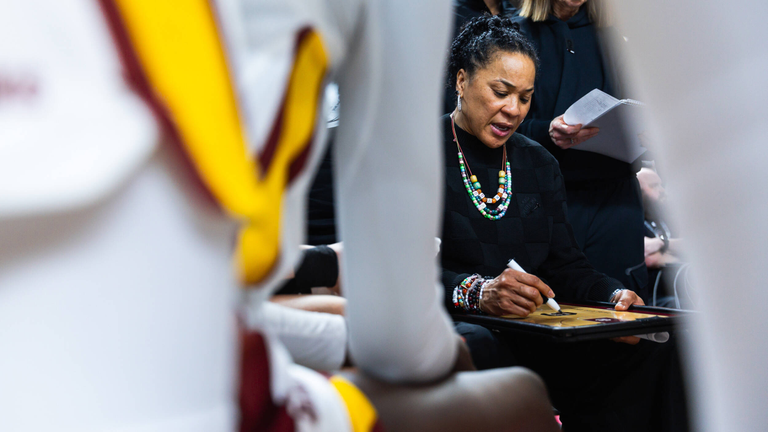 Dawn Staley prepares to draw on the board during a timeout.