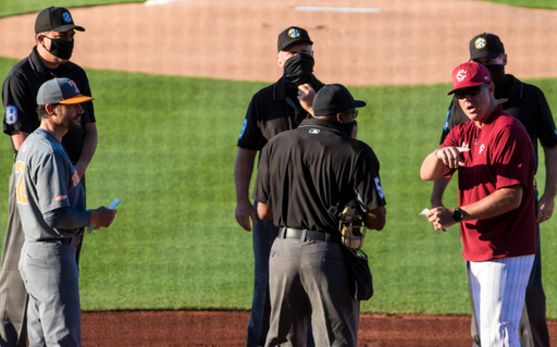 South Carolina Gamecocks head coach Mark Kingston, right, and Tennessee Volunteers head coach Tony Vitello go over ground rules before their game.