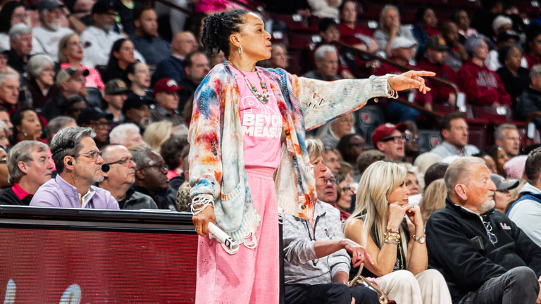 Dawn Staley points to the court from the sideline.