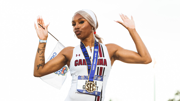 Akala Garrett posing on the podium stand after winning the women's 400-meter hurdles at the SEC Outdoor Championship.