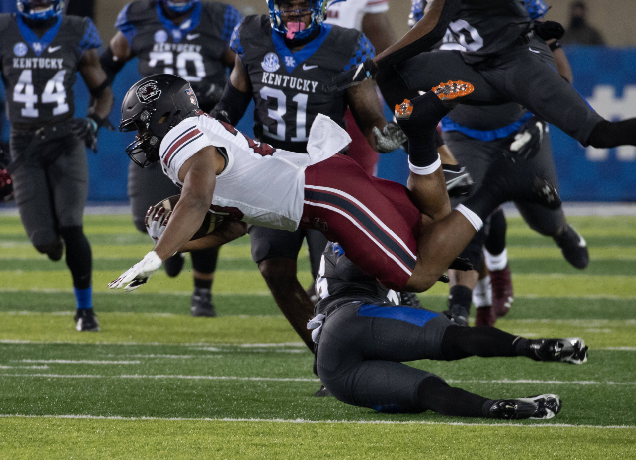 South Carolina Gamecocks running back Kevin Harris (20) got upended by Kentucky Wildcats defensive back Tyrell Ajian (23)  as Kentucky played South Carolina  on December 5, 2020.  Photo by Mark Cornelison 