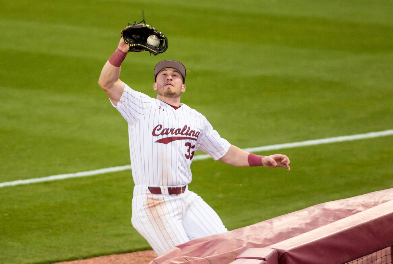 South Carolina Gamecocks outfielder Brady Allen (33) catches a pop fly before crashing into the railing.

South Carolina vs. Dayton Baseball, Feb. 19, 2021, Founders Park, Columbia, SC.

Photo by Jeff Blake