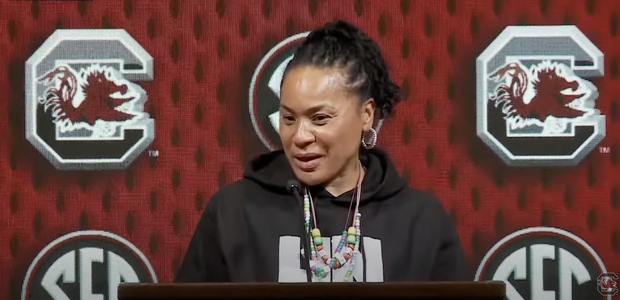 Dawn Staley at the podium talking with media at SEC Media Day on 10/16/24