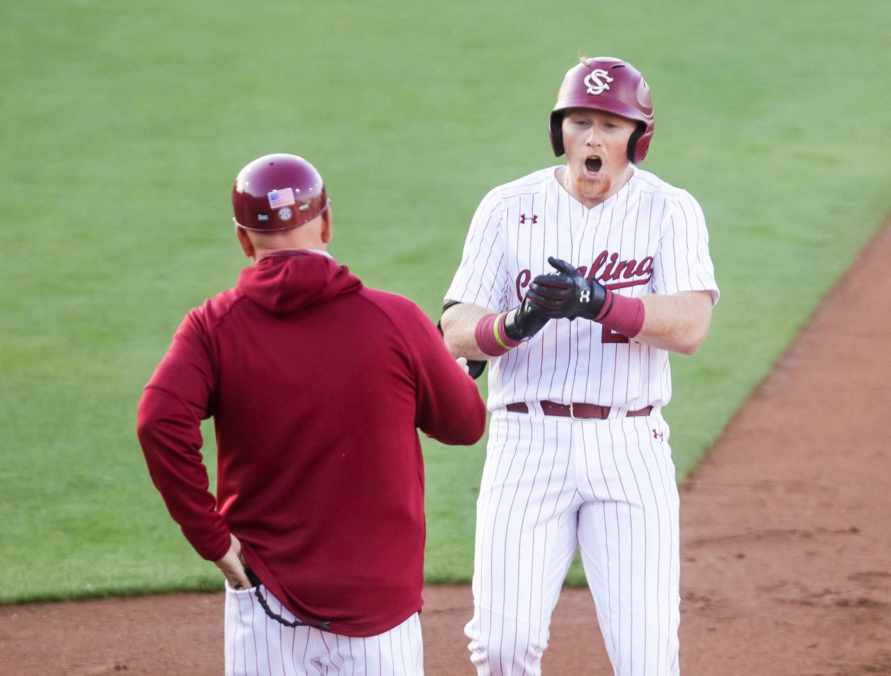 South Carolina Gamecocks infielder David Mendham (26) celebrates a single against the Arkansas Razorbacks during the first inning.