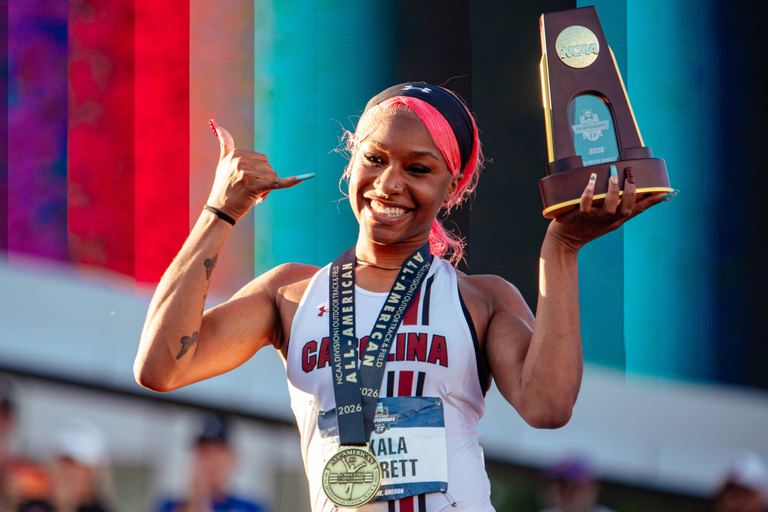 Akala Garrett on the podium after winning the 400-meter hurdles at the NCAA Outdoor Championship.