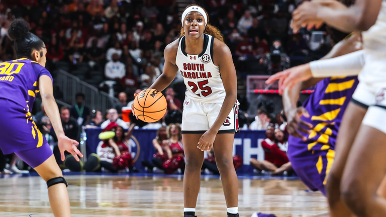 Raven Johnson dribbles at the top of the key looking over the LSU defense.