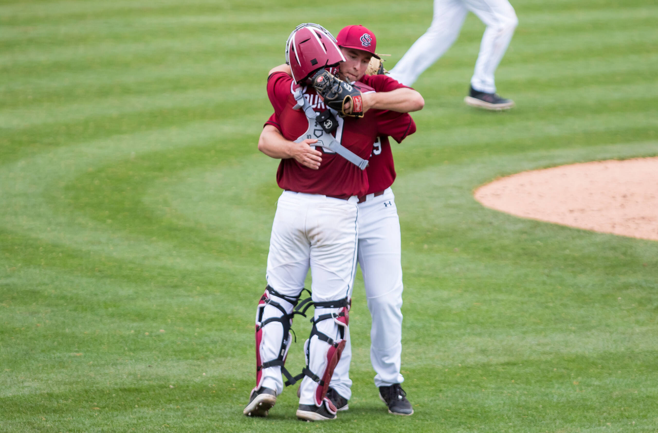 South Carolina Gamecocks pitcher Brett Kerry (49)  and South Carolina Gamecocks catcher Colin Burgess (10) celebrate a sweep of the Florida Gators.