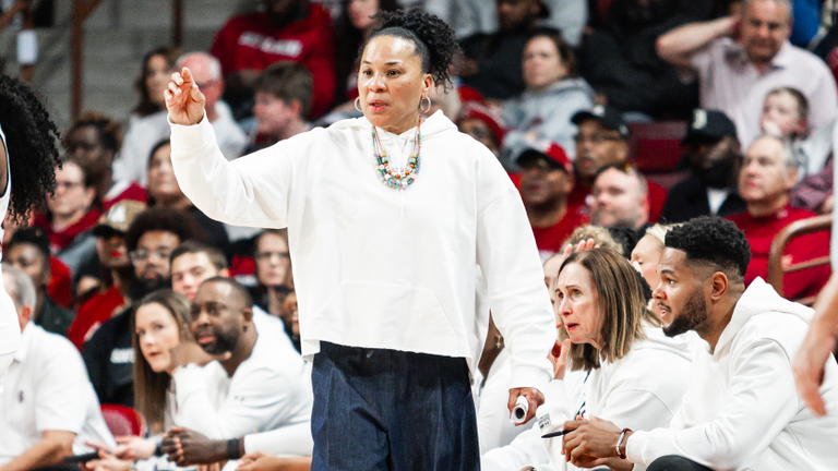 Dawn Staley gestures toward the court from the sideline.
