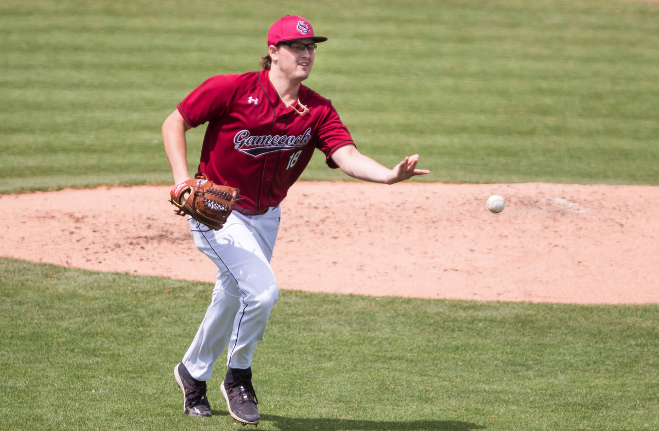 South Carolina Gamecocks pitcher Julian Bosnic (18) tosses out a Florida Gators runner.