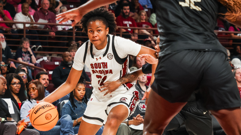 Ayla McDowell drives to the basket against a defender.