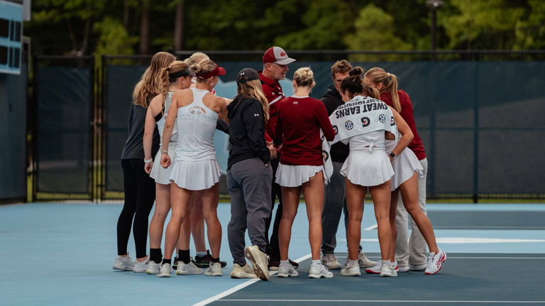 Women's tennis team huddle together pregame