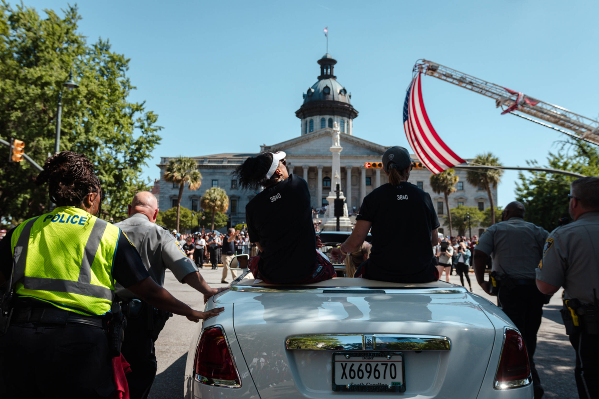 Dawn Staley and Lisa Boyer ride on the back of a Rolls Royce toward the State House in the National Championship parade.