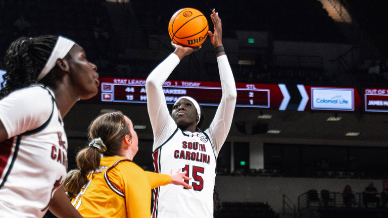 Adhel Tac takes a jump shot over a defender.
