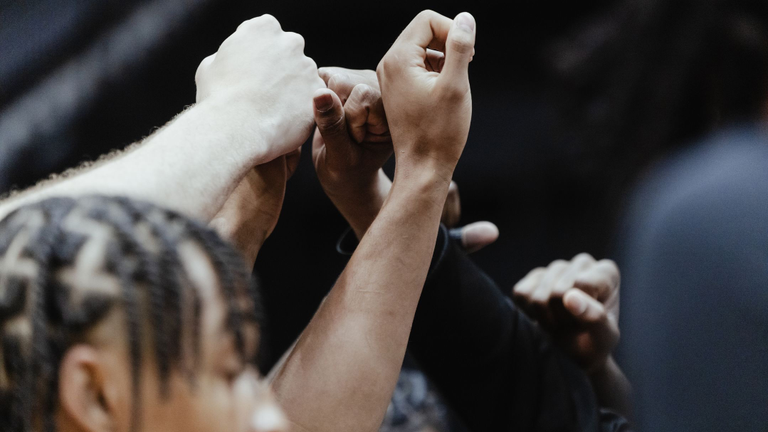 Men's Basketball team huddle after practice.