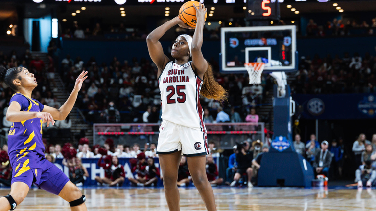 Raven Johnson shoots a 3-pointer with an LSU defending rushing toward her.