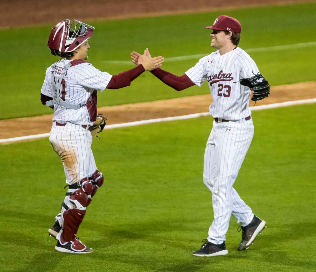 South Carolina Gamecocks Jack Mahoney (23) and South Carolina Gamecocks catcher Colin Burgess (10) celebrate after defeating the Dayton Flyers.South Carolina vs. Dayton Baseball, Feb. 19, 2021, Founders Park, Columbia, SC.Photo by Jeff Blake