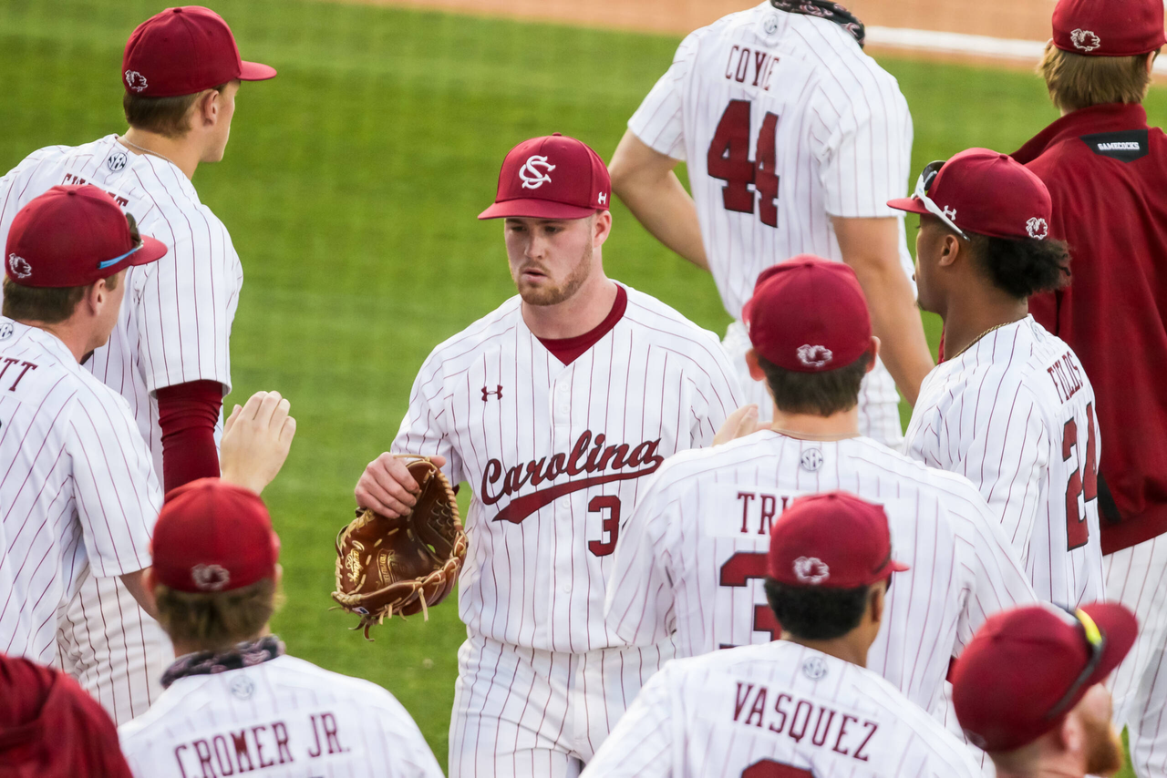 South Carolina Gamecocks pitcher Thomas Farr (34) is greeted by teammates after the second inning against the Arkansas Razorbacks.