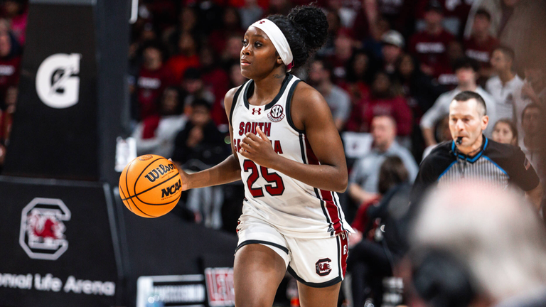 Raven Johnson dribbles the ball up the court.