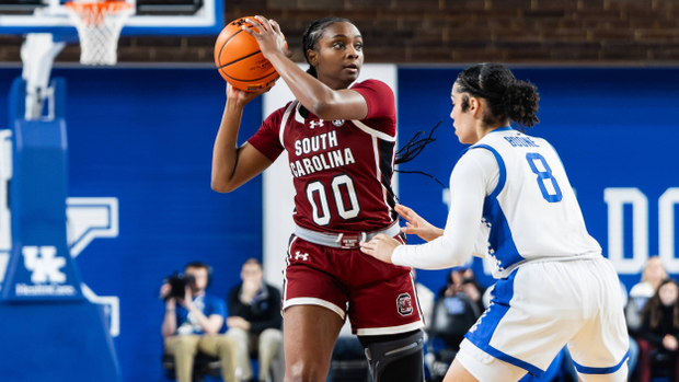 Ta'Niya Latson holds the ball while looking over the Kentucky defense.