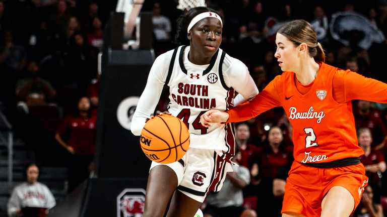 Agot Makeer races the ball up the court against a Bowling Green defender.