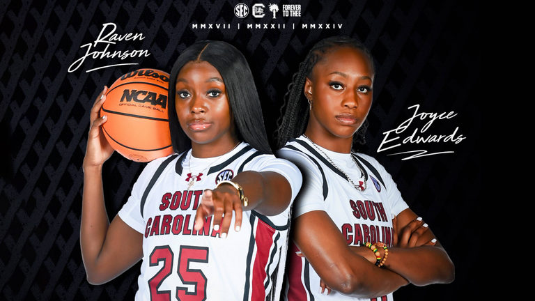 Raven Johnson with basketball on right shoulder pointing with left hand just in front of Joyce Edwards facing to the right with arms folded across her chest, both in white uniforms on black background