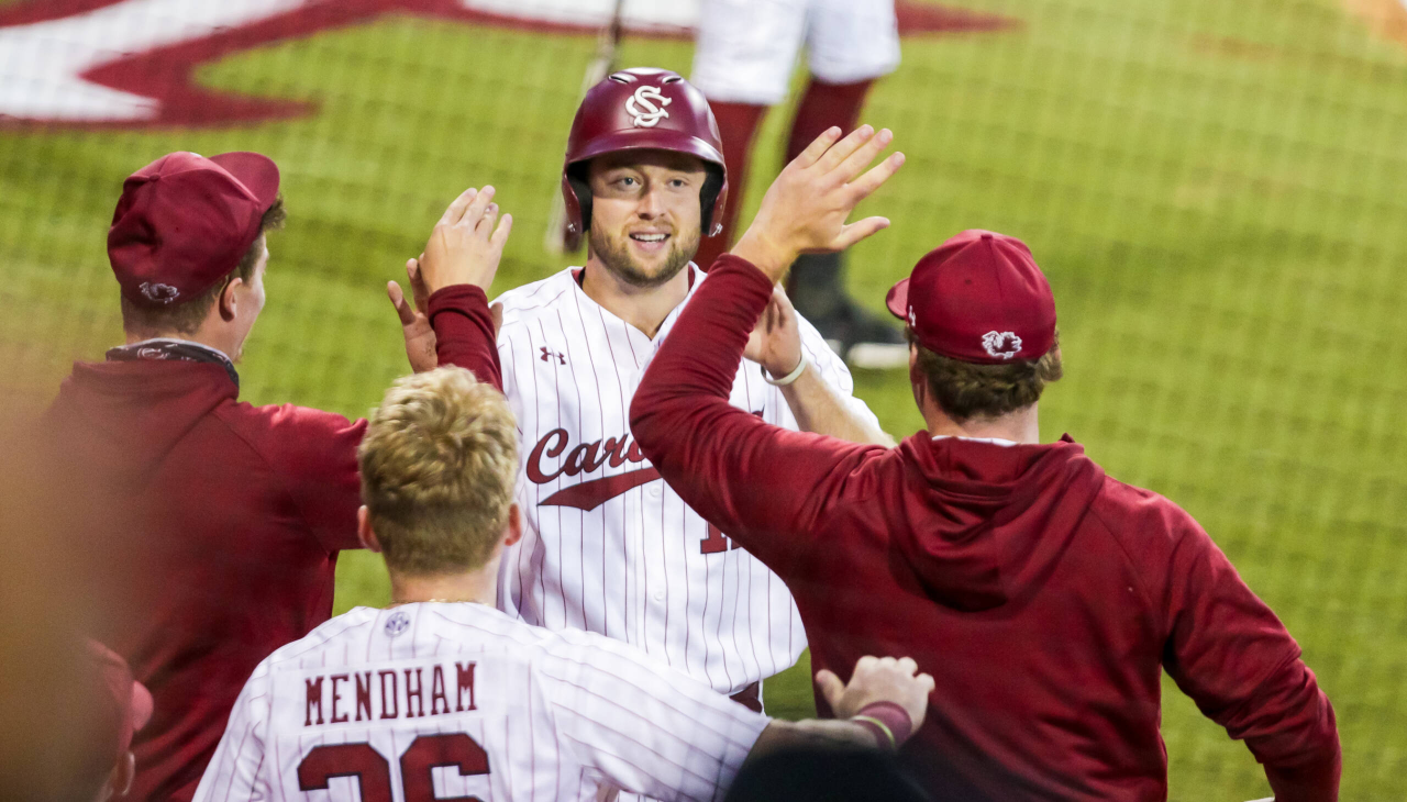South Carolina Gamecocks outfielder Andrew Eyster (11) is congratulated after scoring during the fourth inning against the Arkansas Razorbacks.