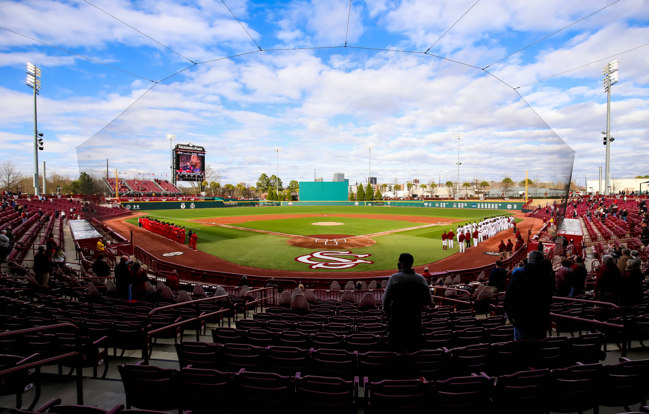 South Carolina Gamecocks and Dayton Flyers players stand for the National Anthem before the season-opening game.South Carolina vs. Dayton Baseball, Feb. 19, 2021, Founders Park, Columbia, SC.Photo by Jeff Blake