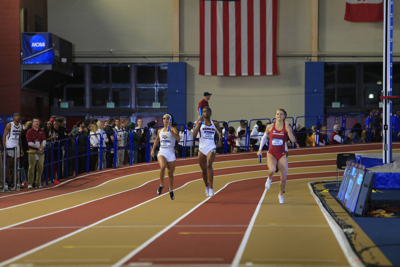 Wadeline Jonathas passes two competitors on the final turn to lead Carolina to a 4x400m relay national championship | March 9, 2019 | Photo by Walt Middleton