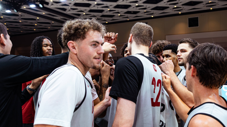 Men's Basketball team huddle after 94-81 win over Victoria (Canada) at the Baha Mar Hoops Summer League